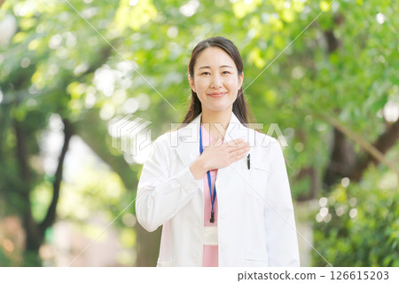 一位身穿白大褂的女士在戶外微笑 126615203