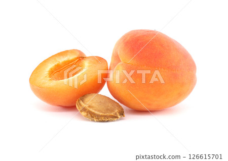 Vibrant apricots, one sliced open, showcasing a delicious and healthy fruit with a white backdrop. Vibrant apricots, one sliced open, showcasing a delicious and healthy fruit with a white backdrop. 126615701