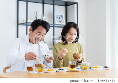 Middle-aged couple eating breakfast Middle-aged couple eating breakfast 126615712