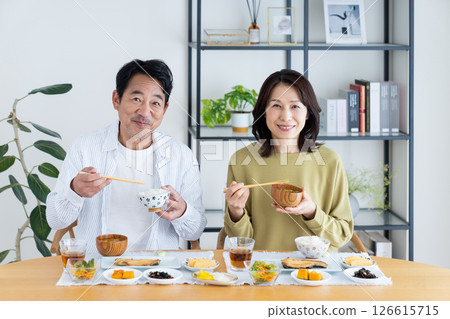 Middle-aged couple eating breakfast 126615715