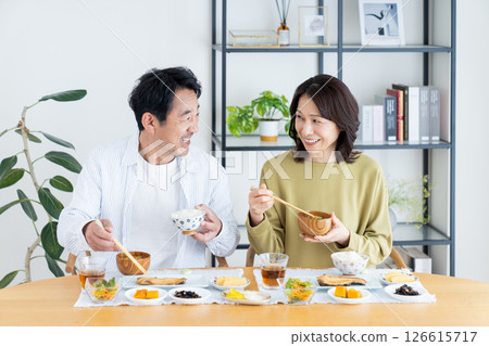 Middle-aged couple eating breakfast 126615717