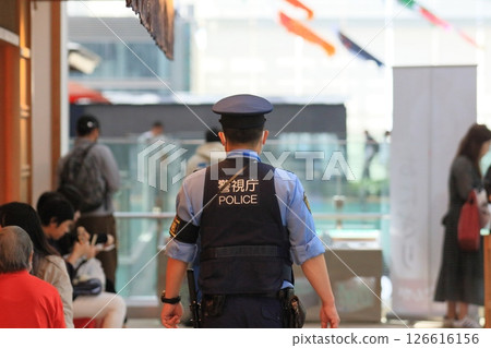 Police officer guarding the airport, rear view, security, police officer of the Metropolitan Police Department Police officer guarding the airport, rear view, security, police officer of the Metropolitan Police Department 126616156