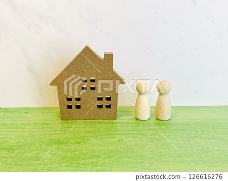 A model of a house and two people (peg dolls) 126616276