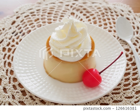 Homemade pudding with cream and cherries on a plate Homemade pudding with cream and cherries on a plate 126616381