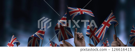 United Kingdom flags in their hands on a blurred urban background 126616415