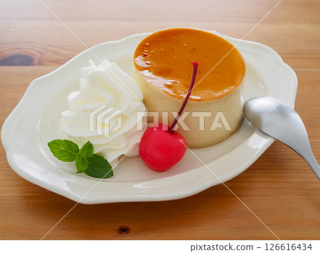 Homemade pudding with cream and cherries on a plate 126616434