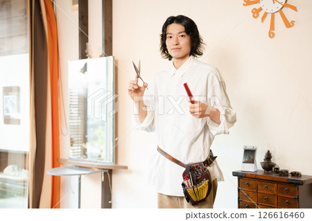 Portrait of a young hair stylist Portrait of a young hair stylist 126616460