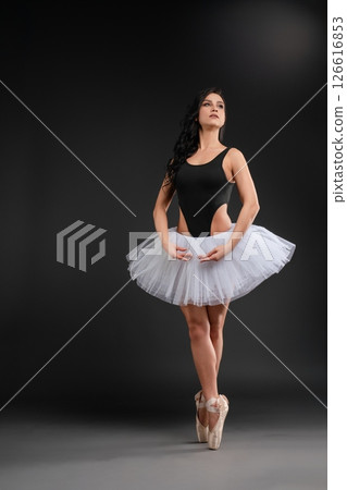 Ballet dancer showcasing elegance and strength in graceful pose Ballet dancer showcasing elegance and strength in graceful pose 126616853