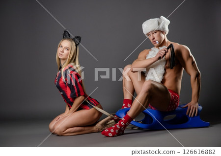 Couple engaged in playful roleplay with themed outfits and accessories 126616882