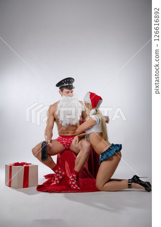 Couple engages in playful roleplay during a themed adult game night 126616892