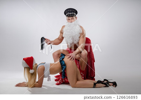 Couple roleplay in festive attire during an intimate game of fetish exploration Couple roleplay in festive attire during an intimate game of fetish exploration 126616893