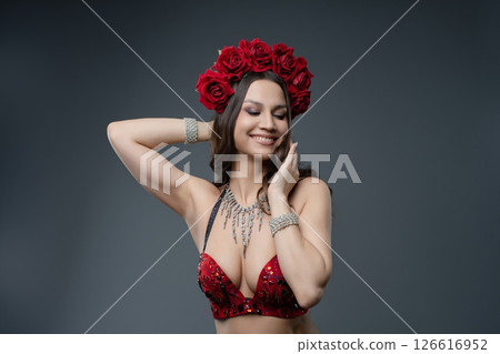 Elegant dancer adorned with roses showcases beauty in striking outfit 126616952