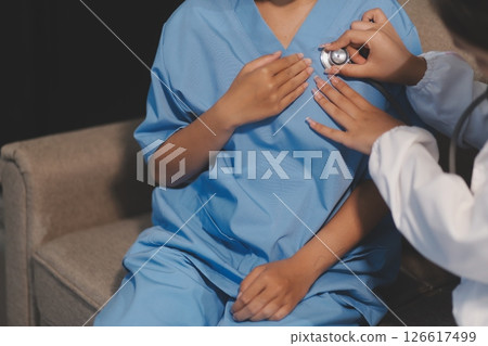 Close-up of doctor listening to a senior woman's heartbeat 126617499