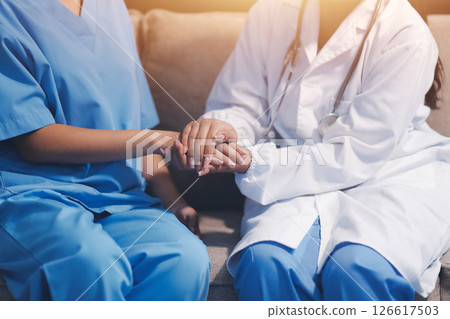 Close up images, The doctor holding hands patient to give advice and encourage To fight the disease And cheer to receive treatment, to elderly patient and health care concept. 126617503