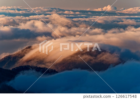 Morning sea of clouds and mountain ranges covered in clouds seen from Mt. Daibosatsu Morning sea of clouds and mountain ranges covered in clouds seen from Mt. Daibosatsu 126617548