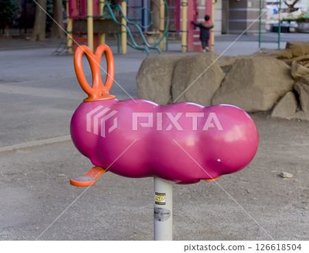 A scene of cute pink insect-shaped playground equipment in a park A scene of cute pink insect-shaped playground equipment in a park 126618504