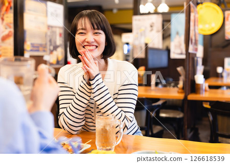 A woman chatting at a tavern 126618539