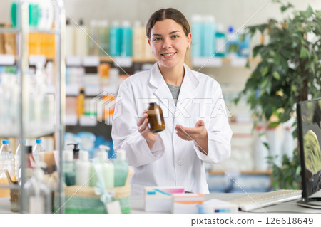 Female pharmacist offering syrup 126618649