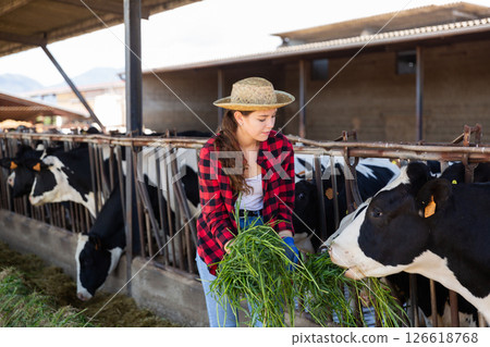 Portrait of woman farmer working in cowshed 126618768