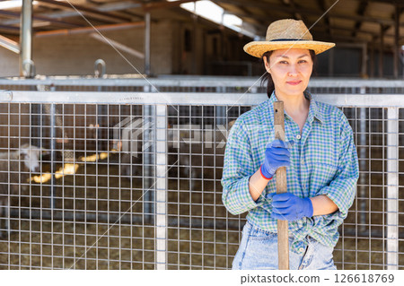 Portrait of a asian woman farmer standing near alpaca pens Portrait of a asian woman farmer standing near alpaca pens 126618769