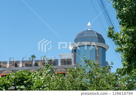 Facade of a multi story building with mirrored windows and balconies. Facade of a multi story building with mirrored windows and balconies. 126618794