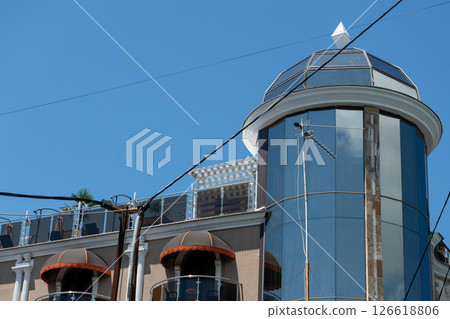 Facade of a multi story building with mirrored windows and balconies. Facade of a multi story building with mirrored windows and balconies. 126618806