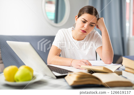 Young tired woman studying during online courses Young tired woman studying during online courses 126619137
