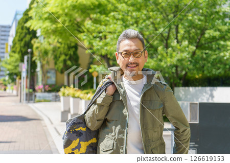 Portrait of a middle-aged man walking in a residential area Portrait of a middle-aged man walking in a residential area 126619153