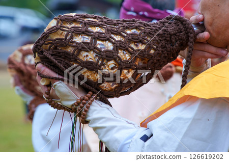 Yamabushi blowing a conch horn at the fire-walking festival Yamabushi blowing a conch horn at the fire-walking festival 126619202