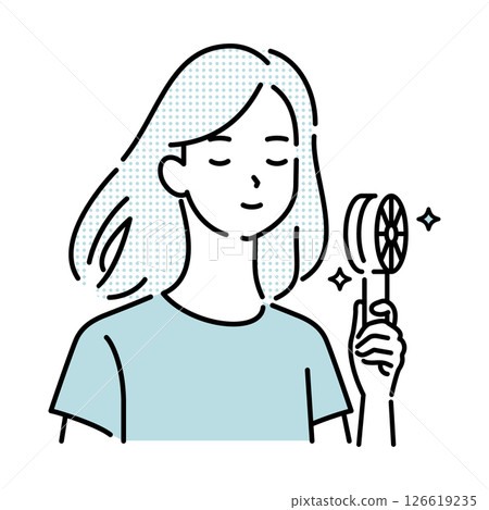 Woman cooling off with a handheld fan 126619235