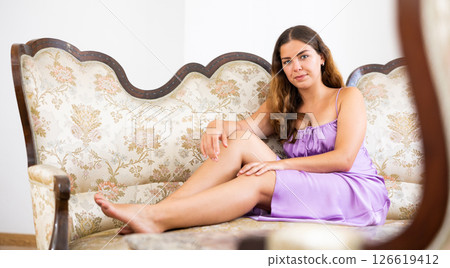 Sensual young woman in nightie on couch Sensual young woman in nightie on couch 126619412