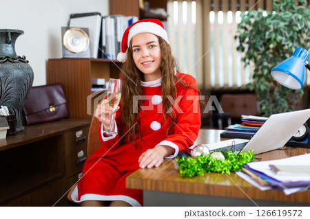 Businesswoman celebrating New Year in office 126619572