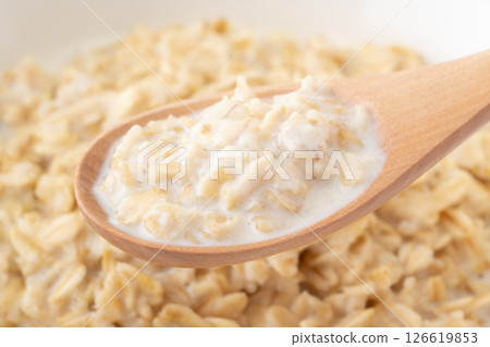 Cheese risotto with oatmeal (rolled oats) on a spoon Cheese risotto with oatmeal (rolled oats) on a spoon 126619853