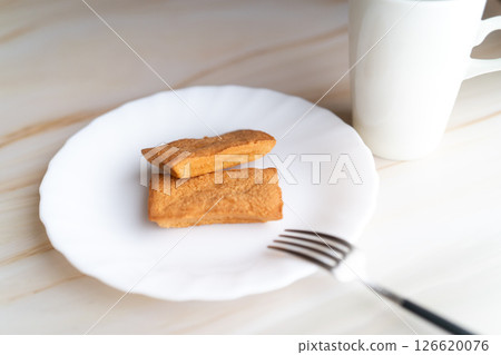 Financiers and white cup on white plate⑤ Financiers and white cup on white plate⑤ 126620076