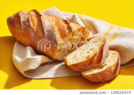 tempting cuban bread in the sunny corner on a cream background, in a clean food photography style tempting cuban bread in the sunny corner on a cream background, in a clean food photography style 126620474