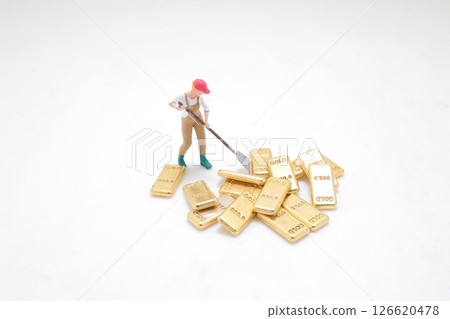 Worker with Gold Bars Depicting Wealth and Resource Concept 126620478