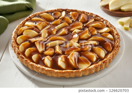 Homemade apple pie with golden crust on white wooden table, surrounded by fresh apple slices and green fabric. Ideal for food blogs, bakery ads, recipe books, and autumn-themed content. Banner Homemade apple pie with golden crust on white wooden table, surrounded by fresh apple slices and green fabric. Ideal for food blogs, bakery ads, recipe books, and autumn-themed content. Banner 126620703