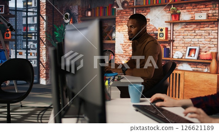 Irked man punching startup office desk in frustration struggling to fix application errors. Upset programmer annoyed by computer bugs while coding in software development agency, camera A Irked man punching startup office desk in frustration struggling to fix application errors. Upset programmer annoyed by computer bugs while coding in software development agency, camera A 126621189
