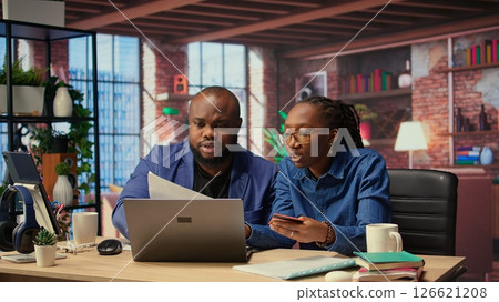 Relaxed people entering card numbers to verify the balance before paying online, e commerce on webpages at home. Couple making web transactions and transferring money. Shopping. Camera A. Relaxed people entering card numbers to verify the balance before paying online, e commerce on webpages at home. Couple making web transactions and transferring money. Shopping. Camera A. 126621208