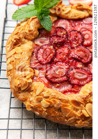 Delicious homemade strawberry galette cooling on a wire rack 126621397