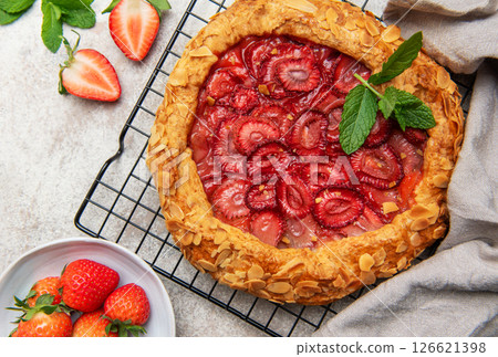 Delicious homemade strawberry galette cooling on a wire rack 126621398
