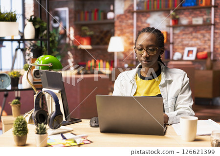Remote worker in home office typing on laptop keyboard, preparing presentation slides, adjusting layouts. Freelancer finishing company project, writing summaries, saving files on notebook 126621399