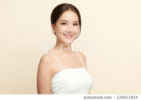 A beautiful young Asian woman with clean, fresh skin against a beige background. Skincare, facial treatment, cosmetology, beauty, and spa. An elegant portrait of an Asian woman. A beautiful young Asian woman with clean, fresh skin against a beige background. Skincare, facial treatment, cosmetology, beauty, and spa. An elegant portrait of an Asian woman. 126621854