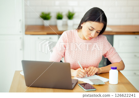 Woman working with laptop computer at home 126622241