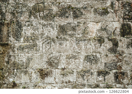 Antique ancient stone wall masonry texture background. Old wall made of beige stone blocks  126622804