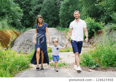 : Family Walking Outdoors Holding Hands Together 126623408