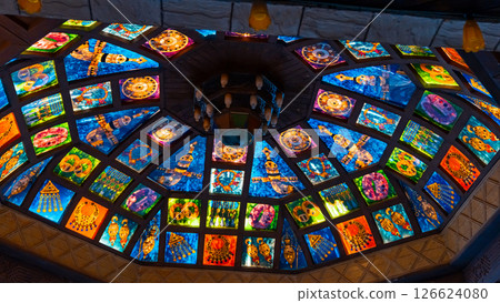 Perforated stucco window decorated with colorful stained glass with floral patterns on a building on the street in the Mutrah souq, Muscat Oman , close up. High quality photo Perforated stucco window decorated with colorful stained glass with floral patterns on a building on the street in the Mutrah souq, Muscat Oman , close up. High quality photo 126624080