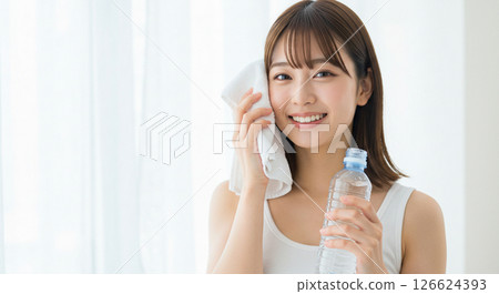 A young woman hydrates herself to prevent heatstroke A young woman hydrates herself to prevent heatstroke 126624393