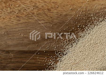 Dry yeast scattered on wooden surface, copy place for text. 126624612