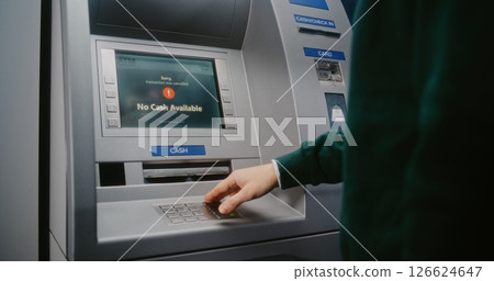Unrecognizable Person Entering PIN Code. Error Message on Cash Machine Display Due to No Cash Available 126624647